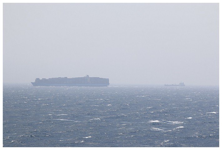 A large Maersk-Line container ship and cargo ship, heading south, towards the Straits.