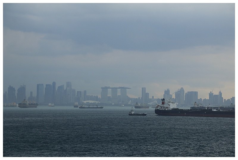 Foreground, anchored ships and the skyline behind.