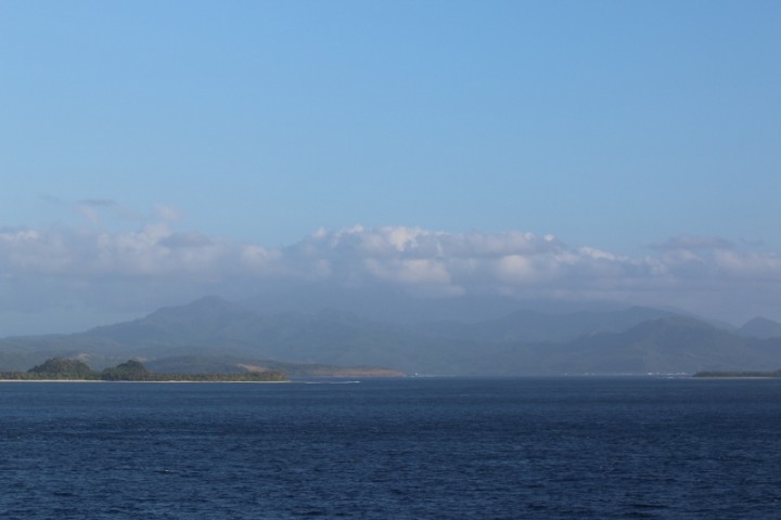 The coast of Luzon.  In the clouds is the peak of an active volcano, Busayan.