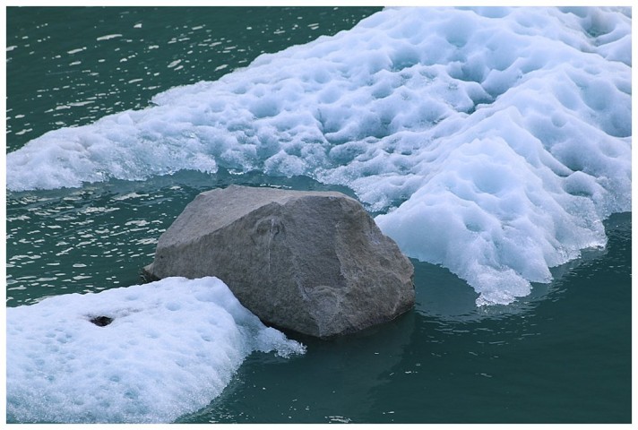 Amazingly, this large rock, carved by the glacier, is still sitting atop the calved iceberg