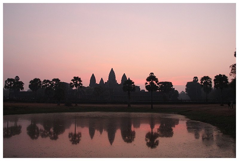 Silhouetted by the rising sun,the 5 towers cast their shadows onto the sacred pond.