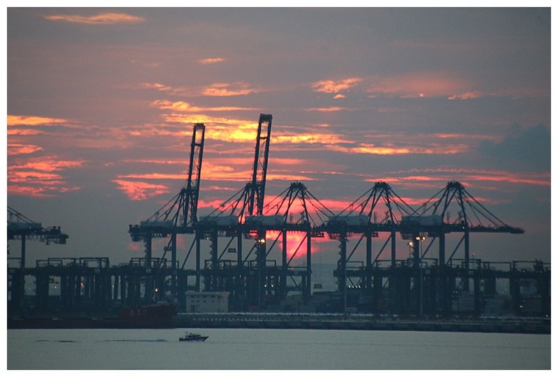 It soon clears and a beautiful sunset behind Portainer cranes on the distant terminal