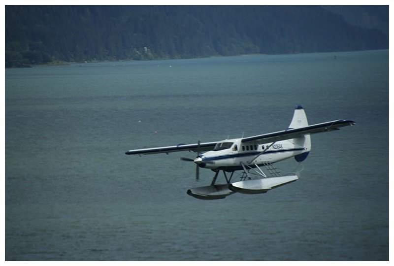 Air traffic abounds in Alaska; here a float-plane passes below the bridge wing on its landing approach